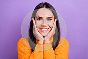 Portrait photo of young cheerful gorgeous woman brunette hair wear orange stylish pullover touch cheeks beauty isolated