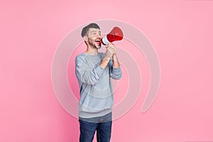 Portrait photo of young funny angry guy hold loudspeaker scream look empty space good offer deal shopping isolated on