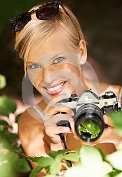 Portrait, photographer and nature with woman in forest for trees, environment and relax. Shooting, camera lens and