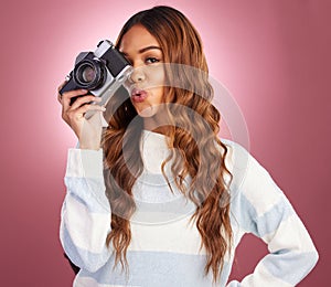 Portrait, photography and happy woman in studio with camera, pose and gen z retro aesthetic on pink background. Face