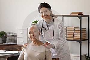 Portrait of physician and senior woman patient looking at camera