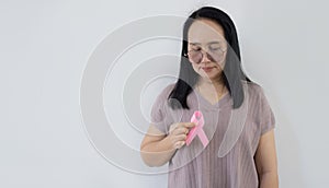 Portrait picture of happy Asian woman with pink ribbon, great for prevention breast cancer concept