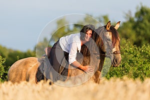 Portrait of a woman on an Andalusian horse