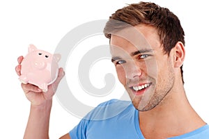 Portrait, piggy bank and happy man in studio for finance, budget or investment. Face, smile and person with money box photo