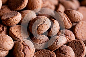 A portrait of a pile of tasty traditional dutch treats called pepernoten or pepernuts. The gingerbread snack is a tradition during