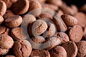 A portrait of a pile of traditional dutch treats called pepernoten or pepernuts. The gingerbread snack is a tradition during the