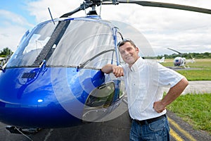 portrait pilot standing in front helicopter