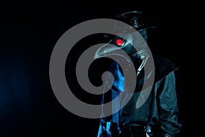 Portrait of plague doctor with crow-like mask isolated on black background. Creepy mask, halloween, historical terrible photo