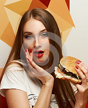 Playful girl posing with burger
