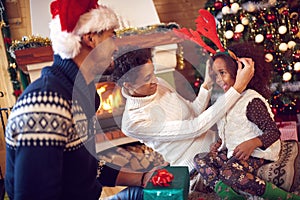 Portrait of playful family and child during Christmas