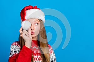 Portrait of playful funky nice girl with blond hair wear red sweater pompom cover eye look empty space  on blue