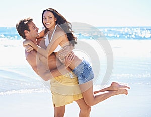 Portrait, playful and happy couple on beach for holiday on tropical island adventure together with waves, love and