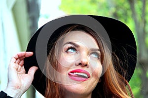Portrait of playful woman in hat