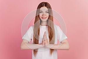 Portrait of pleading girl hold hands together beg gesture