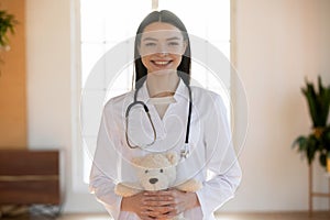 Portrait of pleasant smiling nurse holding toy.