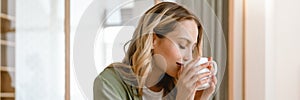 Portrait of pleased blond woman writing down notes