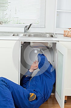 Portrait of a plumber fixing a sink