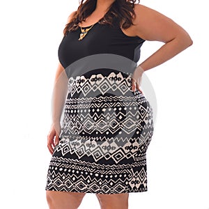 Portrait of plus size model woman wearing XXL black t-shirt and skirt posing isolated on white photo