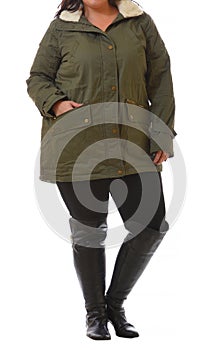 portrait of plus size model woman wearing XXL dark green winter coat and black leggins posing isolated on white background photo