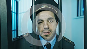 Portrait of a policeman in a prison cell.