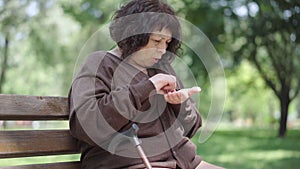 Portrait of poor senior woman counting coins and shaking head. Lonely sad Caucasian retiree lacking money for living