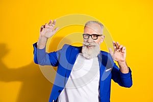 Portrait of positive aged person enjoy partying look empty space have good mood isolated on yellow color background