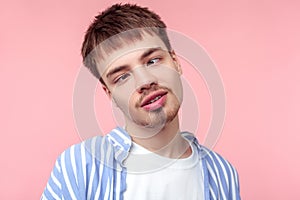 Portrait of positive brown-haired man with small beard and mustache looking with crossed eyes. isolated on pink background