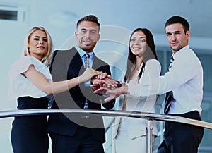 Portrait of positive business group standing on stairs of modern building.