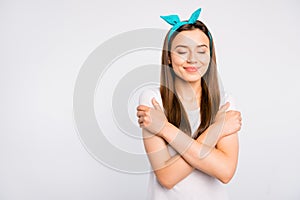 Portrait of positive cheerful charming girl feel dreamy copyspace hug herself enjoy love cuddle wear pinup pin-up style