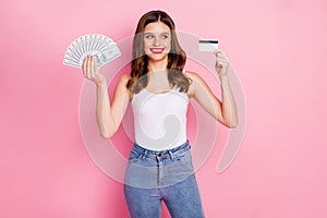 Portrait of positive cheerful freelancer girl hold money fan debit card look enjoy lottery jackpot savings wear white