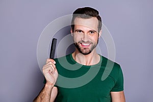 Portrait of positive cheerful guy demonstrate hairbrush enjoy anti dander haircare procedure wear good look outfit