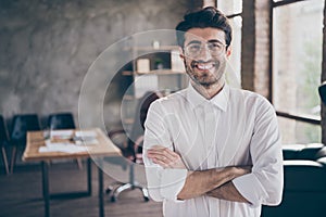 Portrait of positive cheerful middle eastern entrepreneur cross his hands feel real successful start-up owner in photo