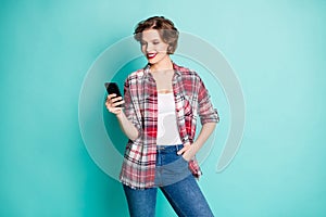 Portrait of positive cheerful modern girl use cell phone read social media information follow comment repost news wear