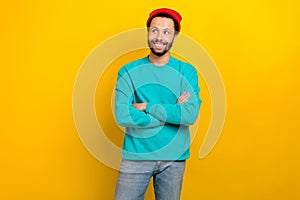 Portrait of positive creative man folded hands look empty space contemplate isolated on vivid yellow color background