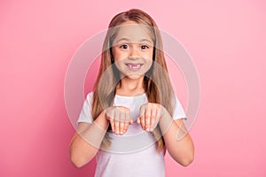 Portrait of positive excited girl toothy smile arms make animal paws  on pink color background