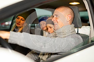 Portrait of a positive family in a car