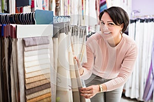 Customer posing near cloth rolls