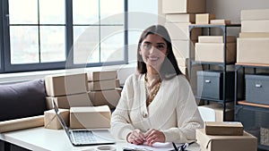 Portrait Of A Positive Female Online Shop Seller In Office