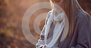 Portrait of positive female walking in woods in autumn