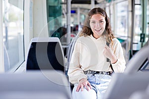 Portrait of a positive girl riding on public transport photo