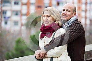 Portrait of positive glad mature couple in city