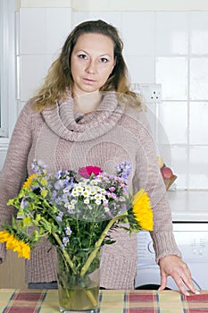 Portrait of positive housewife with flowers