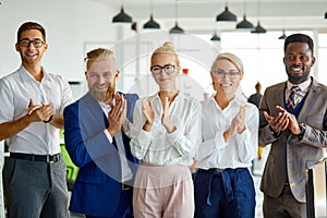 Portrait of positive interracial team looking at camera