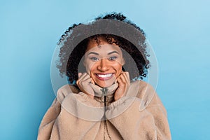 Portrait of positive lady hold artificial fur outfit cold weather enjoy fresh softness isolated blue color background