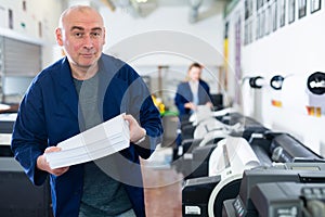 Portrait of positive man printing office worker