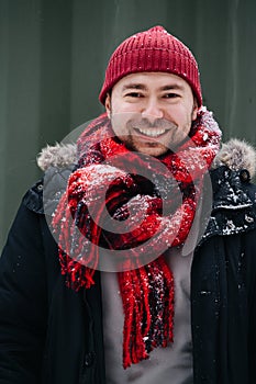 Portrait of a positive middle age man in snowy winter clothes