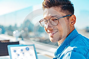 Portrait of positive minded gentleman in casual beaming for camera