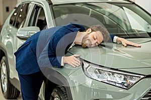 Funny caucasian man buyer in dealership photo