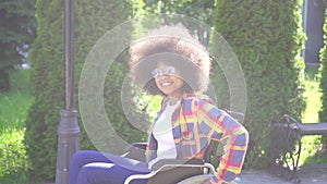 Portrait of a positive smiling young African American woman disabled in a wheelchair looking at the camera