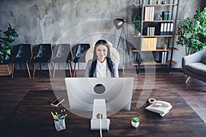 Portrait of positive successful lady sitting chair look screen read email workplace indoors